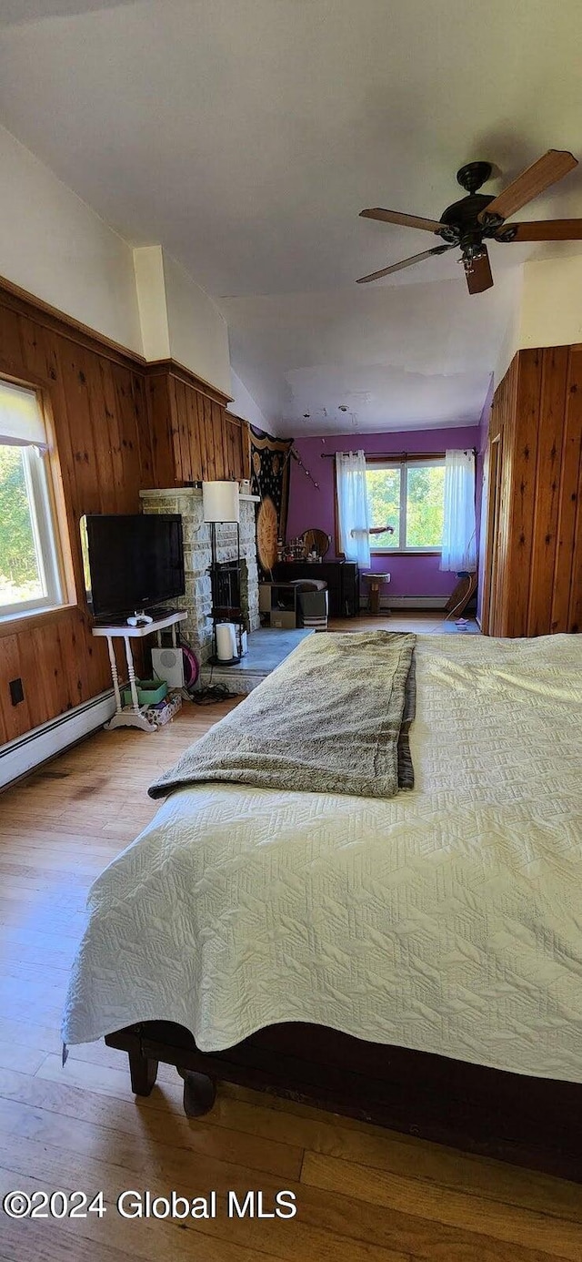 unfurnished bedroom with light hardwood / wood-style floors, multiple windows, and ceiling fan