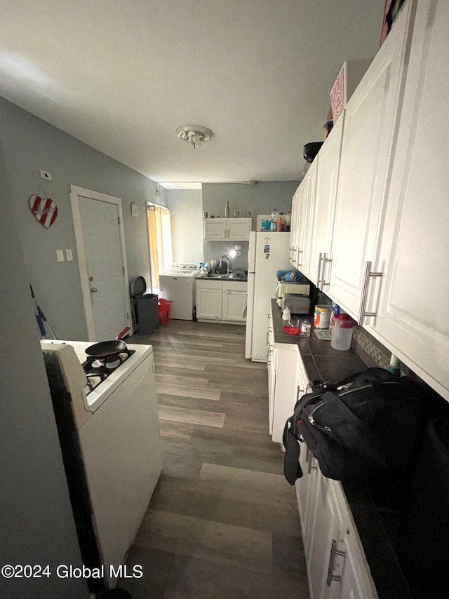 kitchen featuring white cabinets, tile countertops, dark hardwood / wood-style flooring, and white appliances