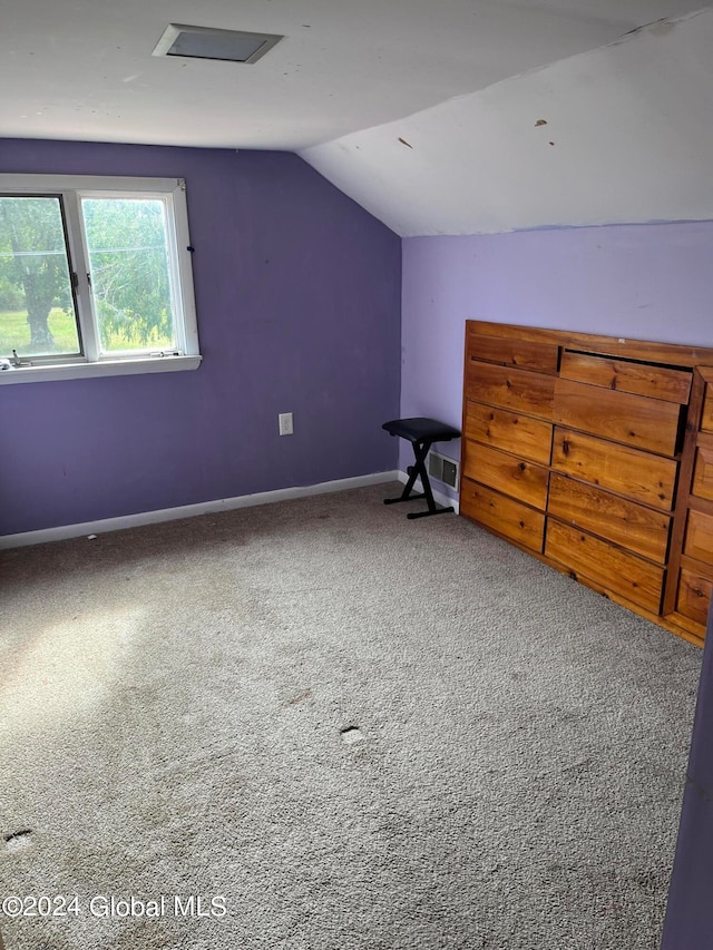 bonus room featuring carpet flooring and vaulted ceiling