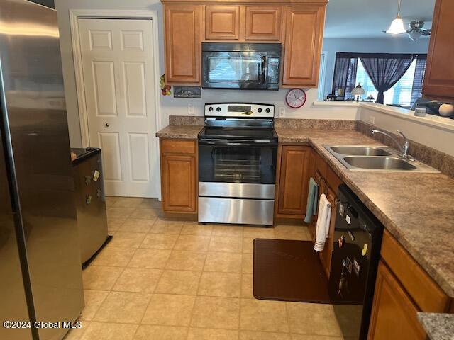 kitchen with black appliances, ceiling fan, decorative light fixtures, and sink