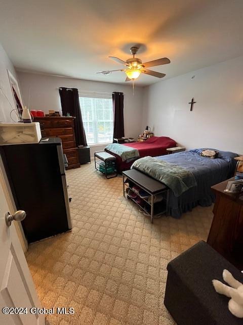 carpeted bedroom with ceiling fan