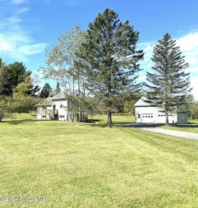 view of yard featuring aphalt driveway, a deck, and stairs