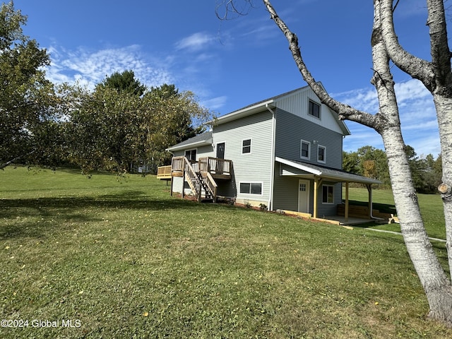 view of side of home with a wooden deck, stairs, and a lawn