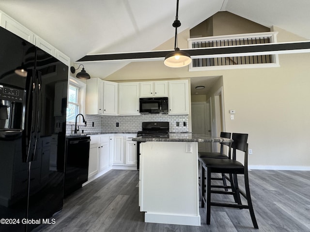 kitchen featuring white cabinets, black appliances, a center island, and dark wood-style floors
