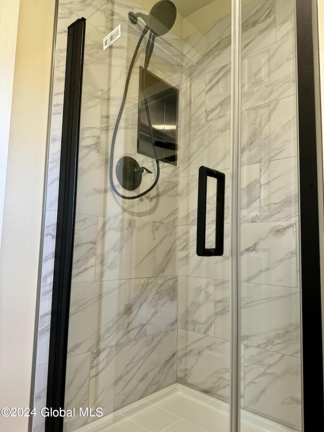 full bath with a marble finish shower