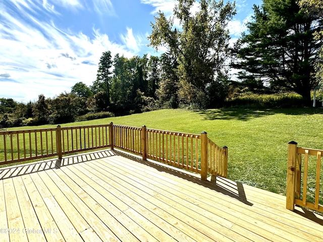 wooden terrace featuring a yard