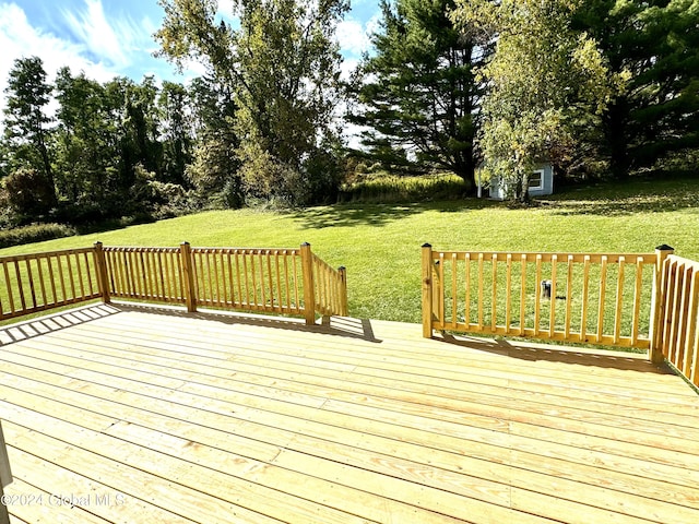 wooden deck featuring a yard