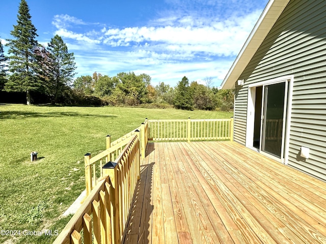 wooden deck featuring a lawn