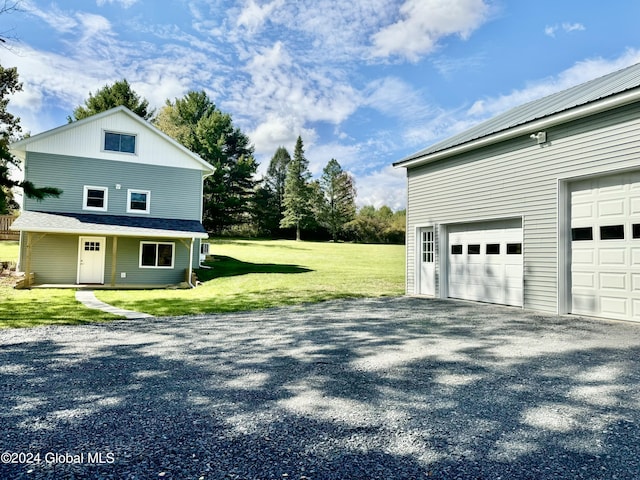 view of home's exterior featuring a garage, driveway, and a lawn