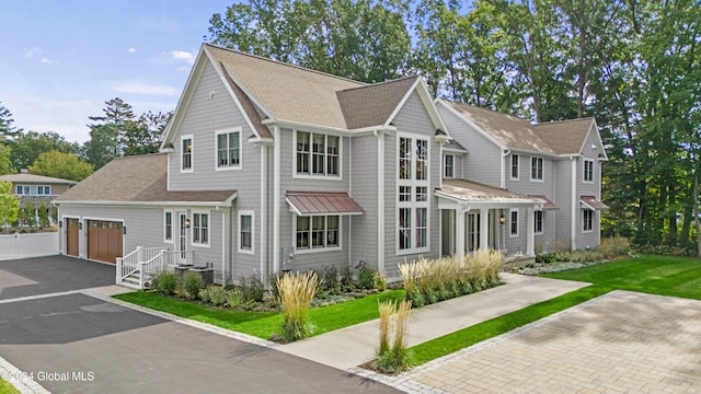 view of front of property with a garage and a front yard