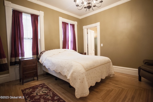 bedroom featuring a notable chandelier, parquet flooring, and ornamental molding