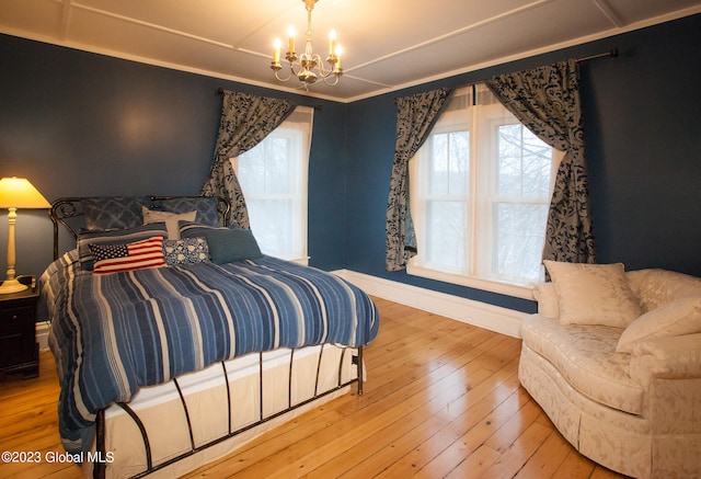 bedroom featuring wood-type flooring and a chandelier