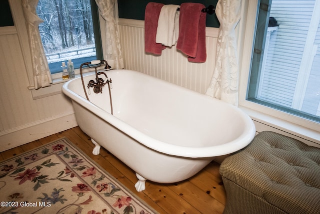 bathroom featuring hardwood / wood-style flooring and a bathing tub