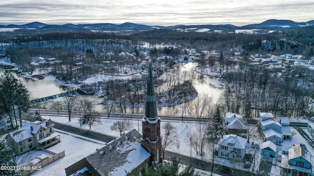 snowy aerial view with a mountain view