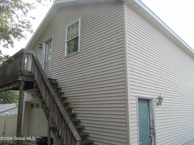 view of side of property featuring a deck and a garage