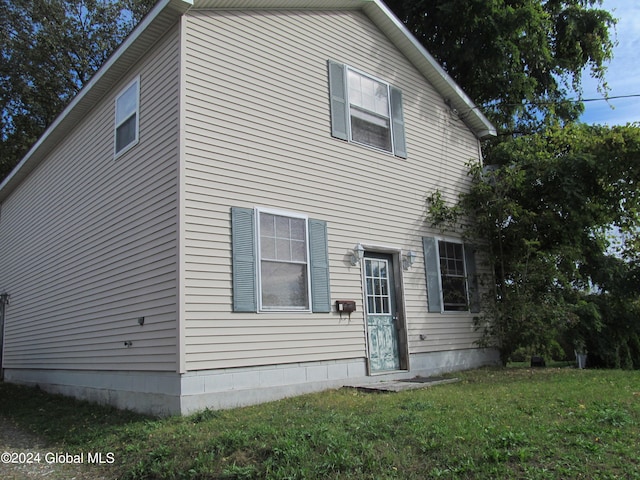 view of side of home featuring a yard