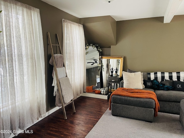 living room featuring ceiling fan, hardwood / wood-style flooring, and beam ceiling