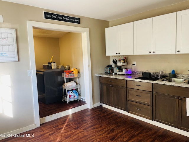 kitchen featuring sink, dark brown cabinets, dark wood-type flooring, white cabinetry, and light stone countertops