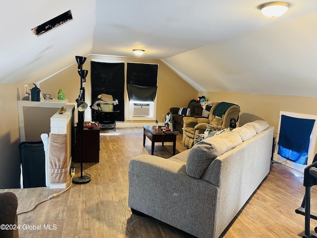 bonus room featuring cooling unit, light hardwood / wood-style floors, and lofted ceiling