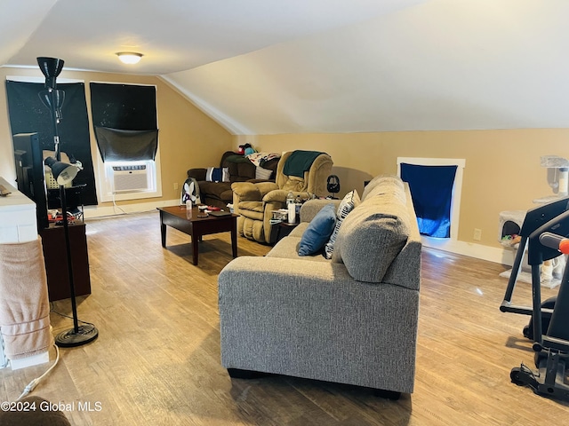 living room featuring wood-type flooring, vaulted ceiling, and cooling unit