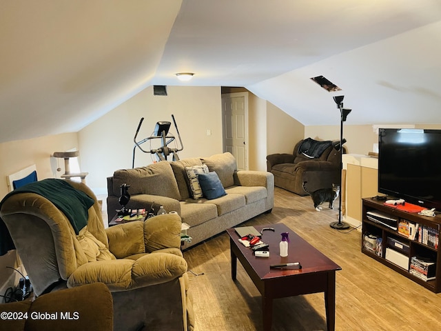 living room featuring vaulted ceiling and light hardwood / wood-style flooring