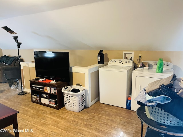 clothes washing area featuring light wood-type flooring and separate washer and dryer