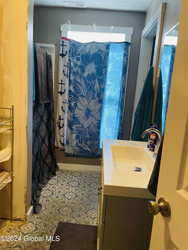 bathroom featuring vanity and curtained shower