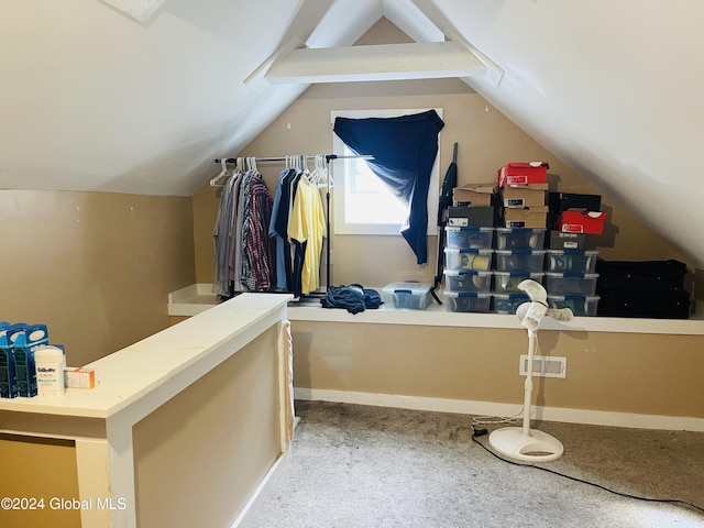 interior space featuring lofted ceiling and carpet