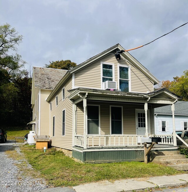 view of front of property featuring cooling unit and covered porch