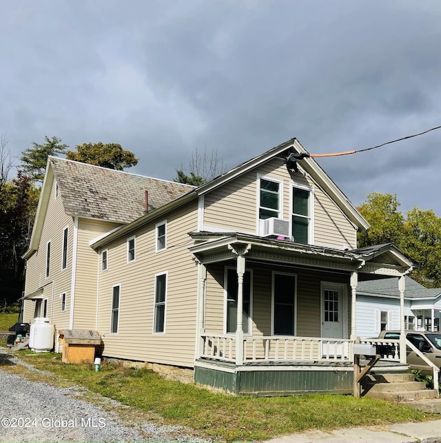 view of front facade featuring cooling unit and covered porch