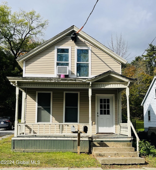 view of front of property featuring cooling unit and a porch