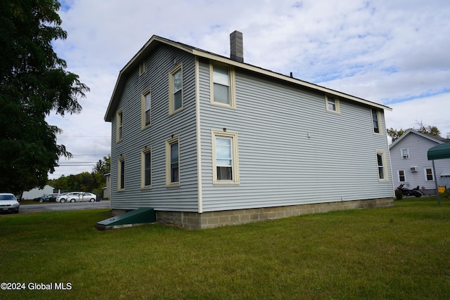 view of home's exterior with a yard