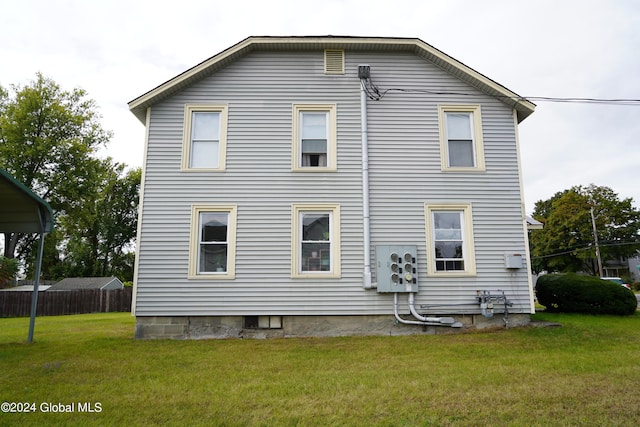 back of property featuring a yard