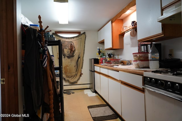 kitchen featuring sink, baseboard heating, gas range gas stove, and white cabinetry