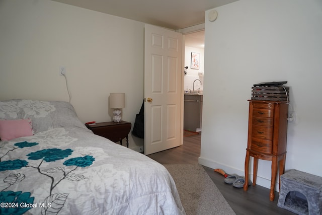 bedroom with dark hardwood / wood-style floors