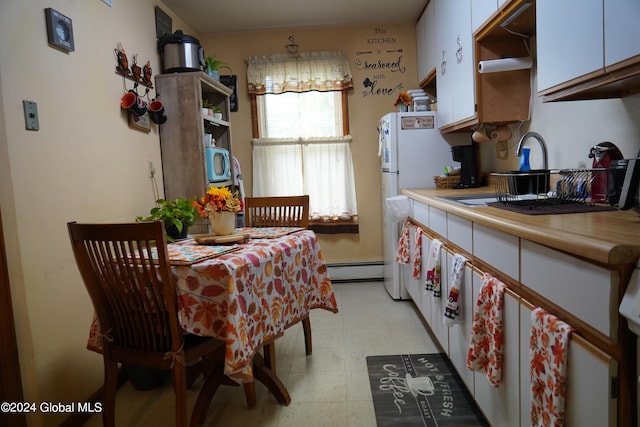 kitchen featuring a baseboard heating unit, white cabinets, tile countertops, and sink