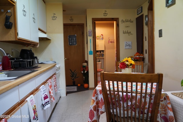 bedroom with a nursery area and sink