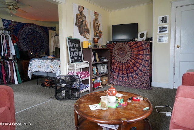 living room with ceiling fan, carpet floors, and ornamental molding