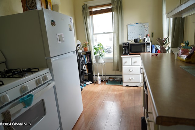 kitchen with light wood-type flooring, white cabinets, and white gas range oven