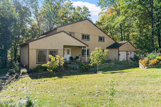 view of front of property with a front lawn and a garage