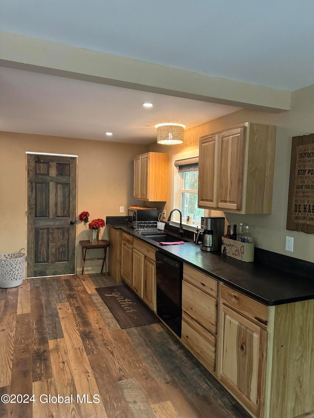 kitchen featuring a sink, dark countertops, dishwasher, and dark wood-style floors