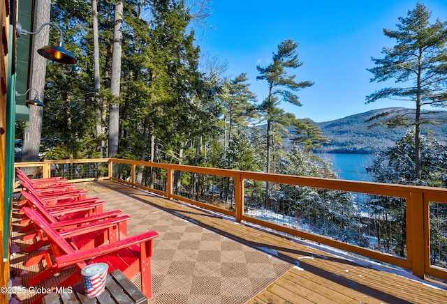 deck with a water and mountain view