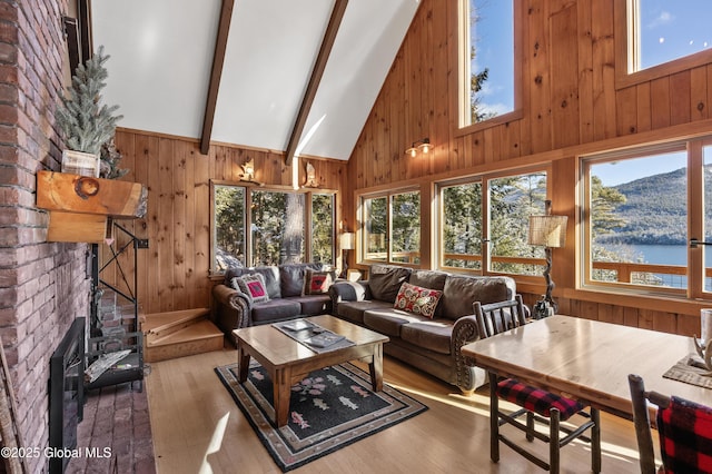 living room featuring wooden walls, wood finished floors, beamed ceiling, and high vaulted ceiling