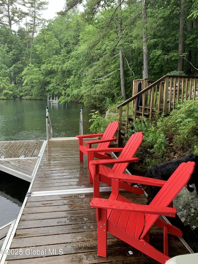 dock area featuring a water view and a view of trees