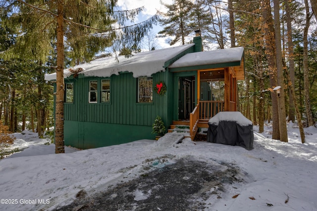 chalet / cabin featuring board and batten siding and a chimney