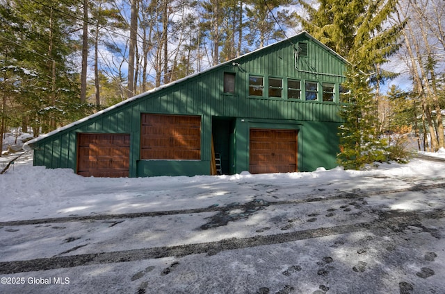 view of snow covered exterior with a garage