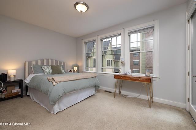 bedroom featuring carpet floors, baseboards, and visible vents