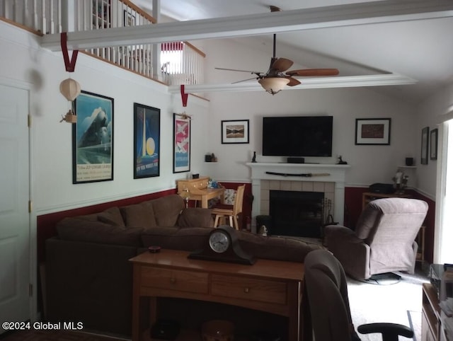 living room featuring a tile fireplace, ceiling fan, and high vaulted ceiling