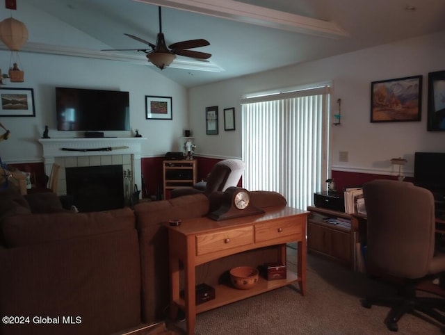 living room featuring ceiling fan, carpet floors, a tiled fireplace, and vaulted ceiling