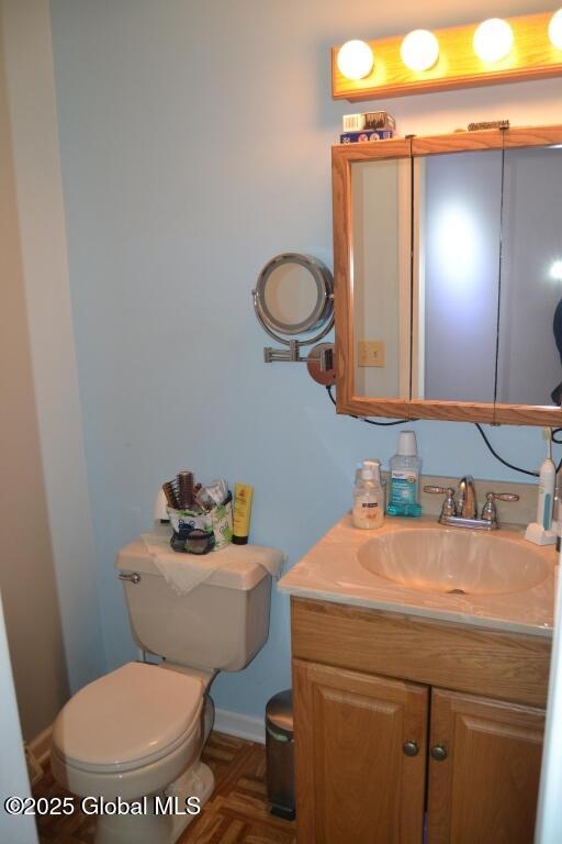 bathroom featuring toilet and vanity